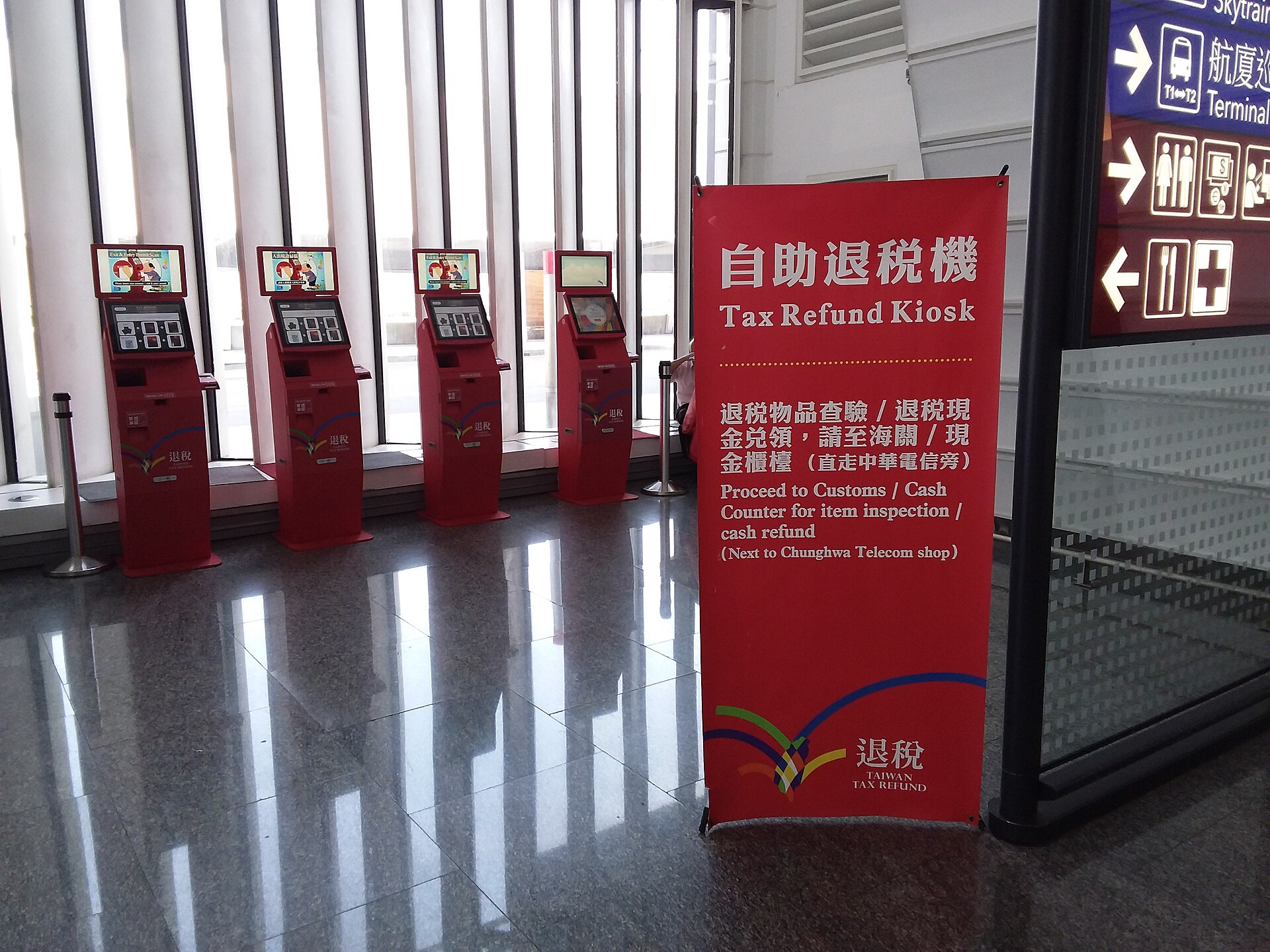 台湾桃園国際空港第一ターミナルに並ぶ赤い自助退税機（Tax Refund Kiosk）と案内サイン